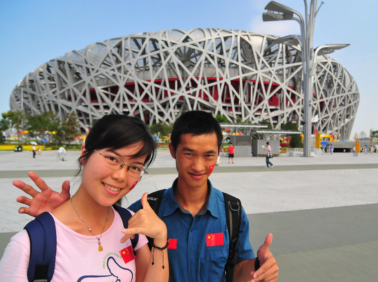 Wei Yi Duo, left, says Michael Phelps is better than Kobe. Her friend, who didn't want to give his name, agrees. Both are college students who came to Beijing to see the Games.